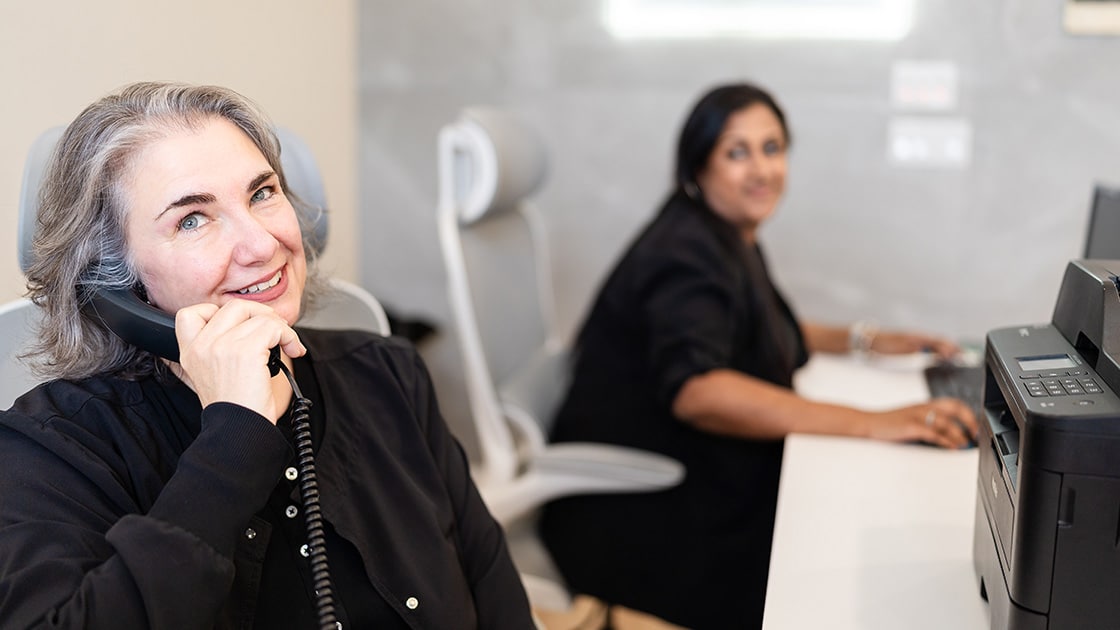 Staff on phone call at front desk